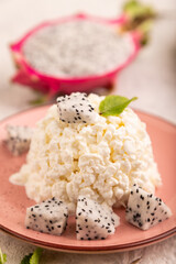 White Сottage cheese, Curd, with Pithaya on gray concrete and linen textile, side view, close up, selective focus
