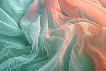 Obraz premium Delicate, flowing fabric drapes in soft, ombre hues of teal and peach.