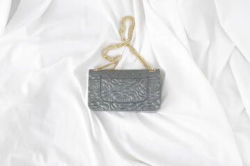 Elegant Gray Leather Handbag with Floral Embossing and Gold Chain Strap