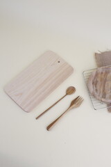 Wooden Kitchen Utensils and Cutting Board on Beige Surface