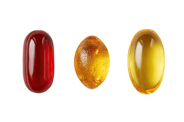 Three capsules, red, amber, and yellow, isolated on black