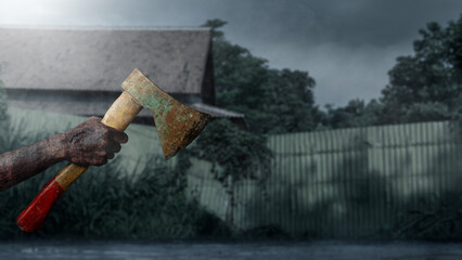 Zombie hands with a bloody wound holding an axe with a night scene background. Zombie, devil, evil, satan, or monster hands. The scene is dark and scary. Concept of Spooky Halloween © Leo Lintang