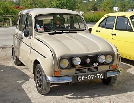Beige Renault 4L parked near a yellow Ford Escort