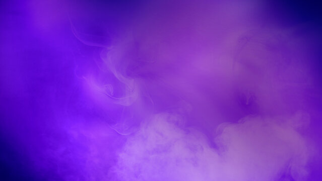 Purple background with smoke and steam. The smoke is thick and dark, and the steam is rising from the ground. Dramatic smoke or fog effect. Mockup. Copy Space. Wallpaper or Halloween background