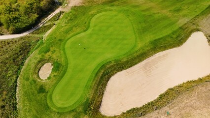 Aerial view of a green golf course with fairways 