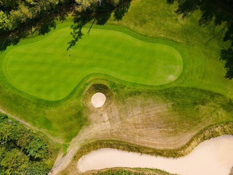 Aerial view of a green golf course with fairways
