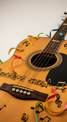 Fototapeta premium A detailed close-up shot of an acoustic guitar, featuring musical notes and colorful ribbons, evoking a sense of musical celebration