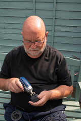 Man assembling electronics with a screwdriver.