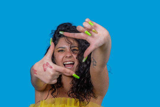 Young influencer making frame gesture with hands and smiling - Powered by Adobe