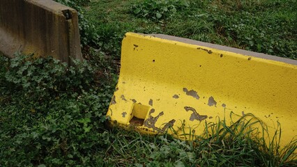 yellow concrete barrier on field