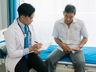 A man holds his hands in front of his genitals, feeling uncomfortable, should consult a doctor,...