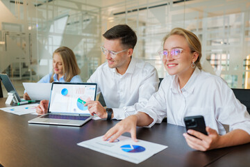 Engaging team meeting in a modern office with digital presentations and collaborative discussions