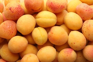 Fresh ripe sweet apricots as background, top view