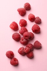 Tasty fresh ripe raspberries on pink background, flat lay