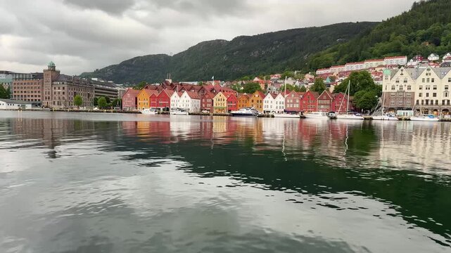 Bryggen and V&aring;gen harbor in Bergen, Norway, with colorful houses reflected in the water