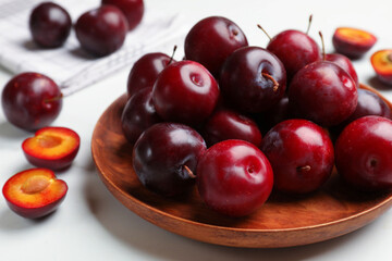 Ripe cherry plums on white table, closeup