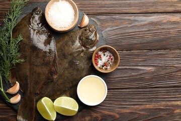 Fresh flounder fish, spices and products on wooden table, flat lay with space for text. Raw seafood
