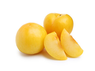 Whole and cut yellow cherry plums isolated on white