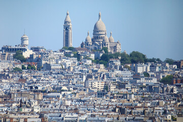 Zoomed view of Montmartre hill from the Arc de Triomphe at a hot and sunny day
