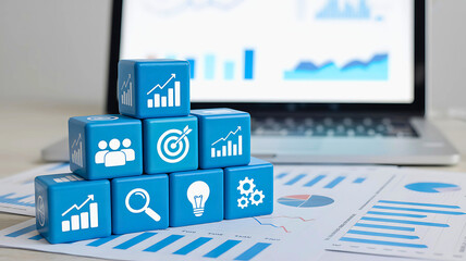 Concept of business strategy and analysis. Blue blocks with icons for growth, goals, and teamwork stacked on financial reports.