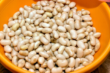 There are boiled white beans in a deep bowl.