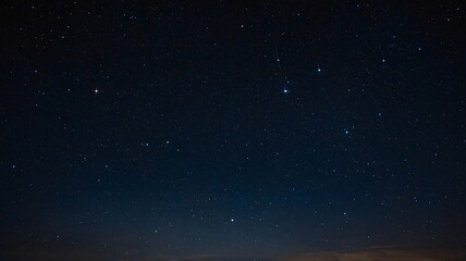 Obraz premium A breathtaking night sky filled with numerous stars and a faint meteor streaking across the dark expanse.