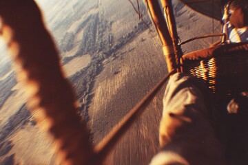 Hot air balloon ride provides breathtaking views of the landscape at sunrise over the countryside in a clear morning sky