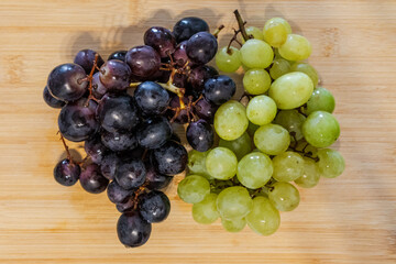 Healthy Fresh Grapes – Black and Green Bunches on Wooden Table