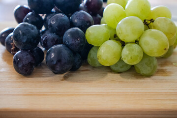 Healthy Organic Grapes – Black and Green Fruit on Wooden Table