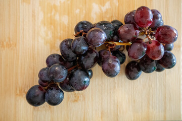 Fresh Black Grapes on Wooden Background – Healthy Food Concept