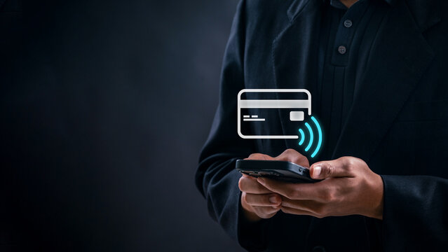 Businessman using smartphone for secure contactless payment with credit card icon, representing digital wallet technology, fintech innovation, and mobile finance in a modern cashless economy
