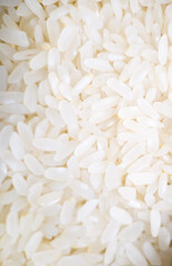 Closeup of uncooked white rice grains in a pile