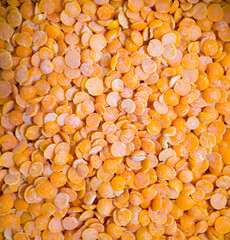 Close up of raw orange lentils with textured surface