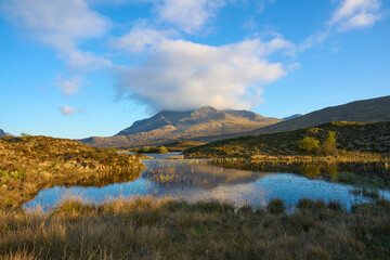 moody highland lanscape with loch and bog on the Isle of Skye, Scotland, UK