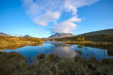 moody highland lanscape with loch and bog on the Isle of Skye, Scotland, UK