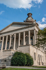 Fototapeta premium Front entrance to the copper domed state capital building in Columbia South Carolina with clouds in blue sky in background