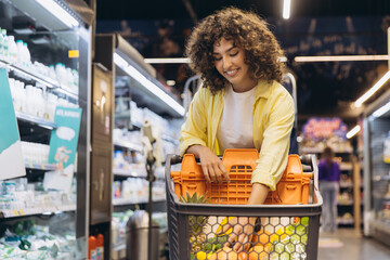 Young Woman Choosing Fruits and Vegetables in Supermarket