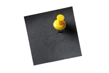 A single bright yellow pushpin centered on a dark gray or black square sticky note