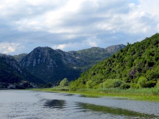 Serenity at Skadar Lake, Where Mountains Embrace Tranquil Waters in Montenegro