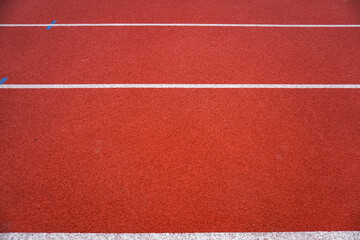 Fototapeta premium Red running track for athletics at the stadium. Stadium for running and other sports.