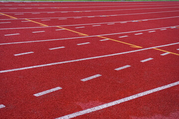 Red running track for athletics at the stadium. Stadium for running and other sports.