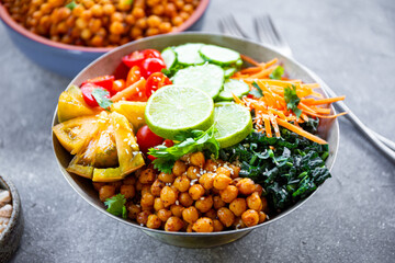Buddha bowl - vegetarian bowl with chickpeas and fresh vegetables on the table