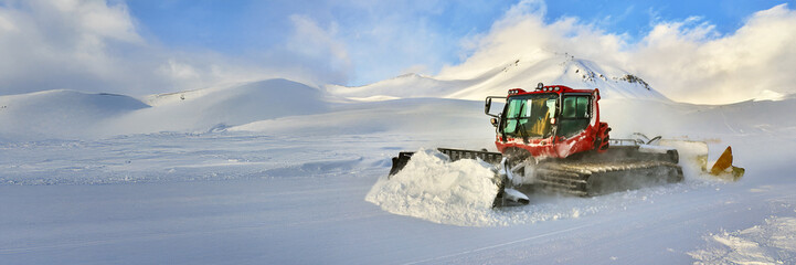 Snowplow in Action on Winter Mountain Wide Banner
