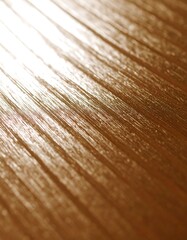 Fototapeta premium Close-up of a golden, textured surface with diagonal lines