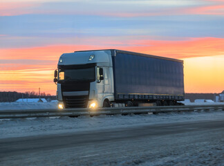 Big Truck moves on the road in winter morning