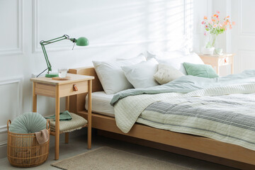 Bedside tables with decor near bed indoors