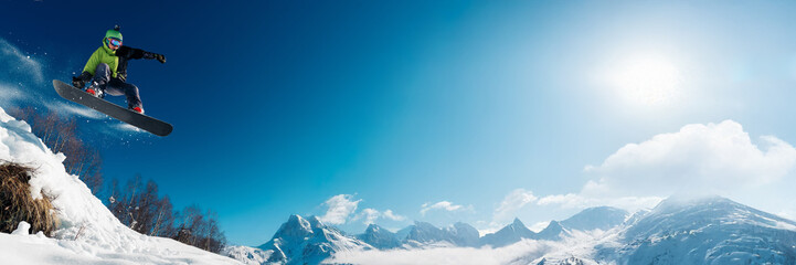 Snowboarder Jumping in Wide Mountain Banner with Copy Space © Аrtranq