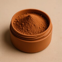 A small terracotta pot filled with fine reddish brown powder against a neutral background