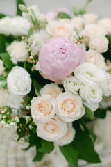 Beautiful floral arrangement featuring peonies and roses in soft pastel tones placed elegantly for decoration