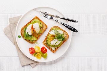 Delicious avocado toasts topped with perfectly cooked poached eggs